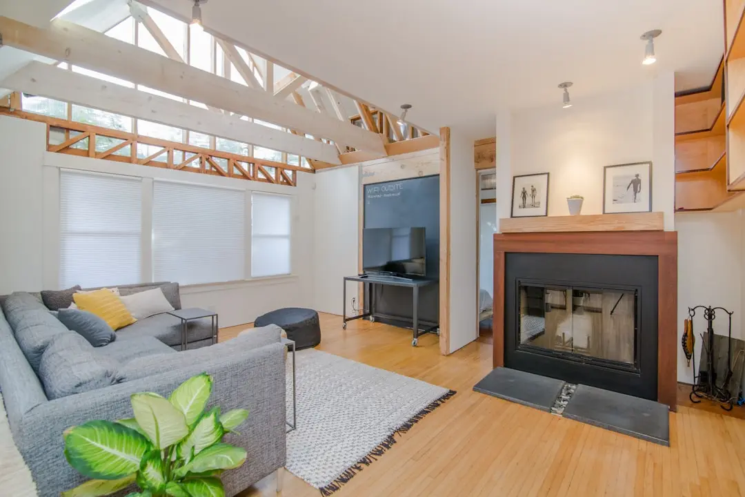 Bright open living room with gray sectional and skylights